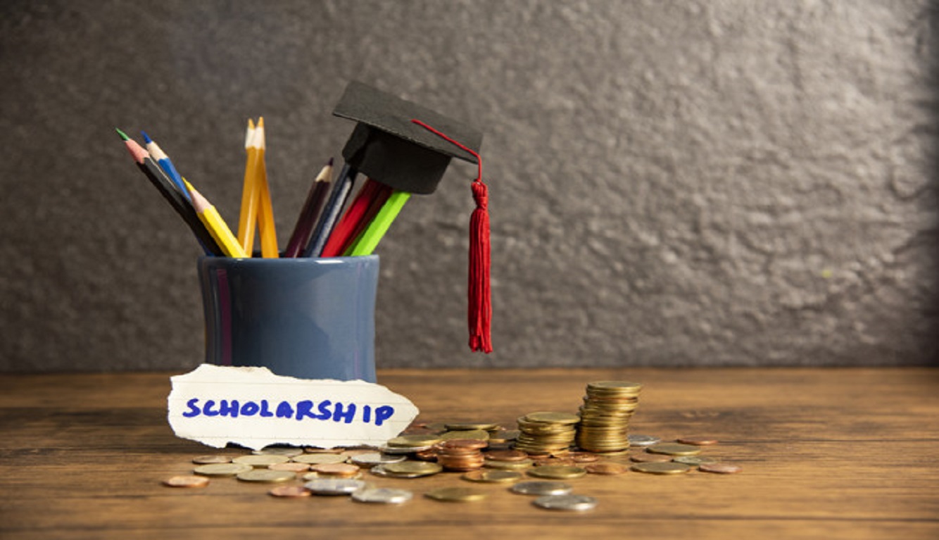 Education And Back To School Concept With Graduation Cap On Penc